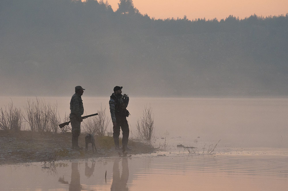 Two hunters are scouting the hunting area