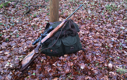 A hunting rifle and a hunting backpack