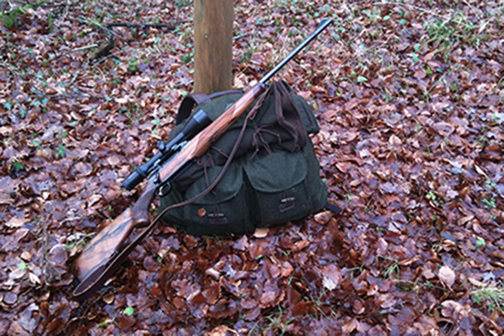 Essential hunting gear includes hunting backpack and shotgun