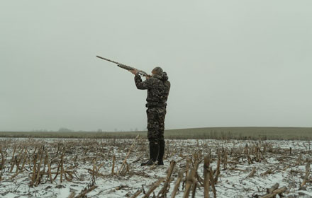 Hunter in hunting boots is shooting