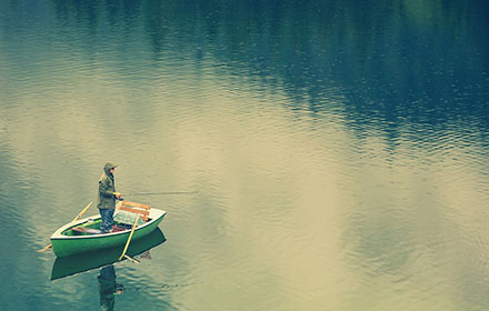 A fisherman is on the boat