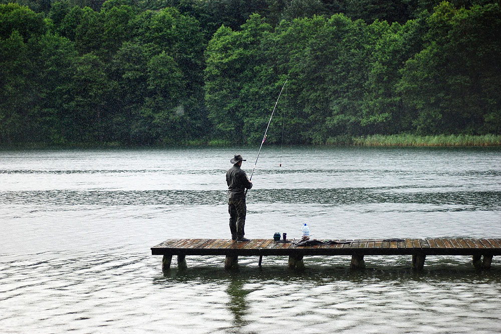A fisherman is fishing on the deck