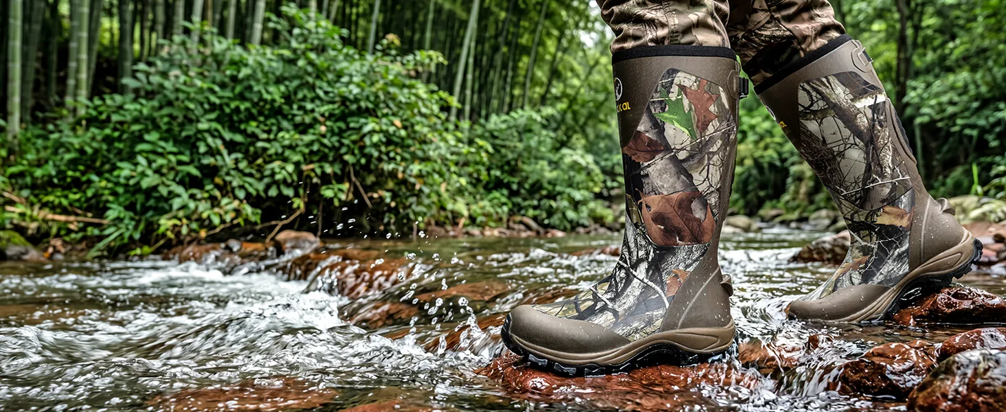 Man wearing snake proof boots walking in shallow water, showing 100% waterproof feautre