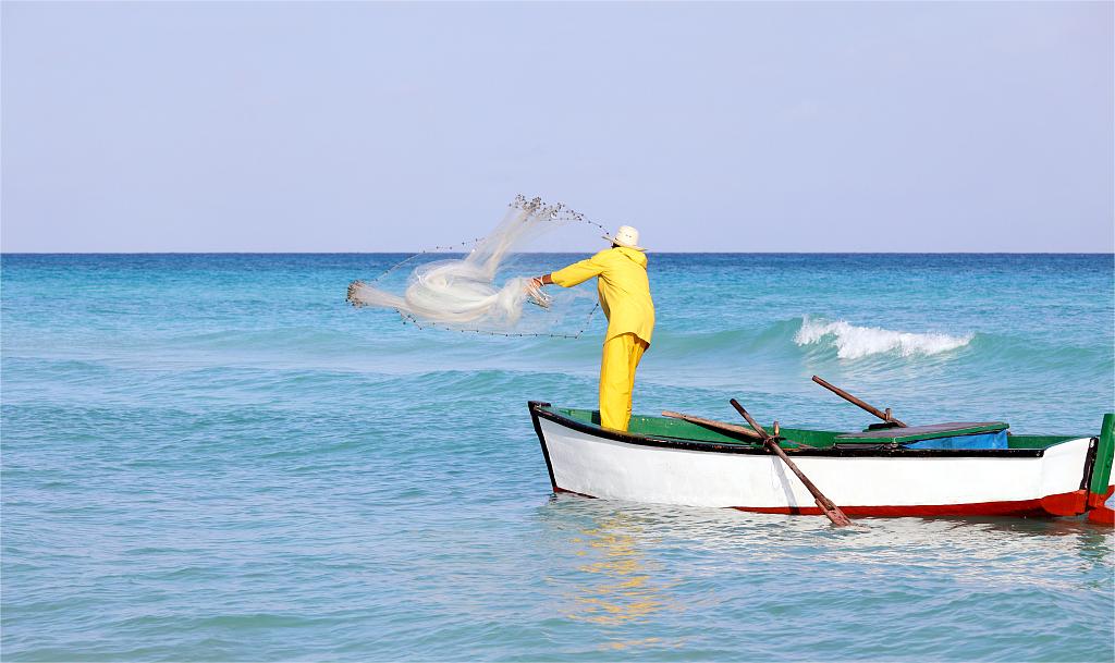 a fisherman is fishing on the sea