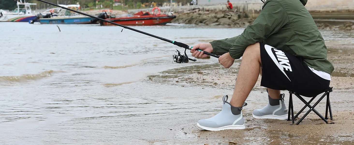 Man wearing ankle fishing boots while fishing on a sandy beach