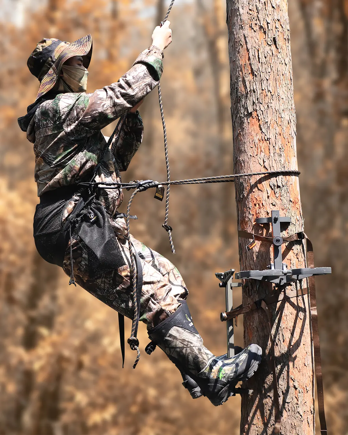 Hunter using a tree saddle while hunting from a tree