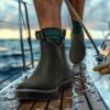 a man is wearing Kalkal fishing deck boots on a wet boat