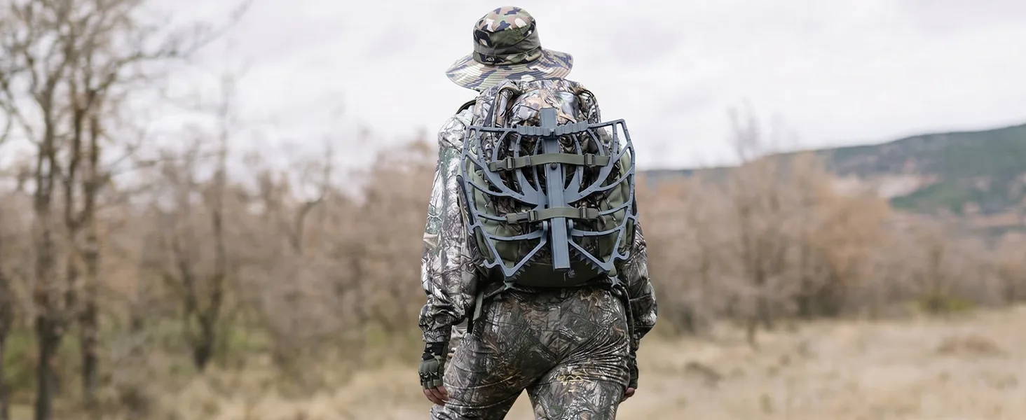Hunter carrying Kalkal saddle hunting platform through the woods