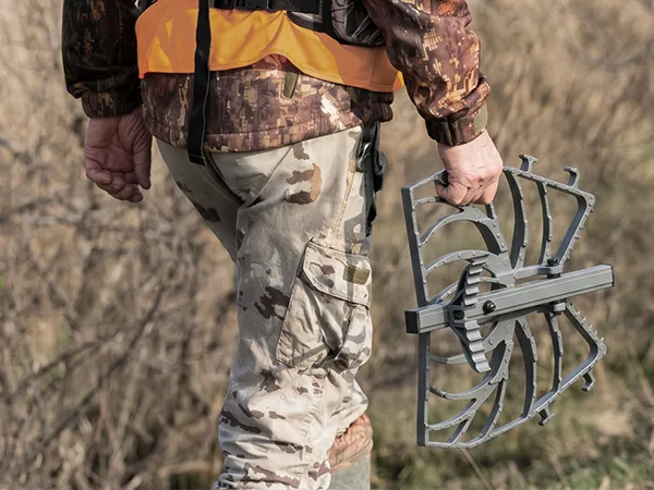 Hunter carrying a foldable tree saddle platform on the way to a hunting setup