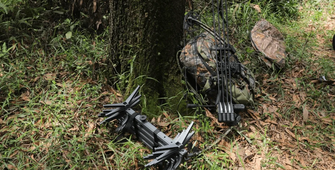 hunting gear and backpack under a tree in hunting spot