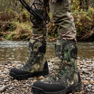 Hunter wearing camo hunting boots while walking through the woods