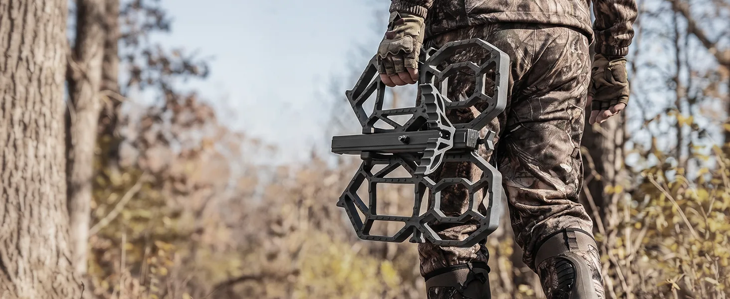 Hunter carrying Kalkal model KK132 saddle hunting platform through the woods