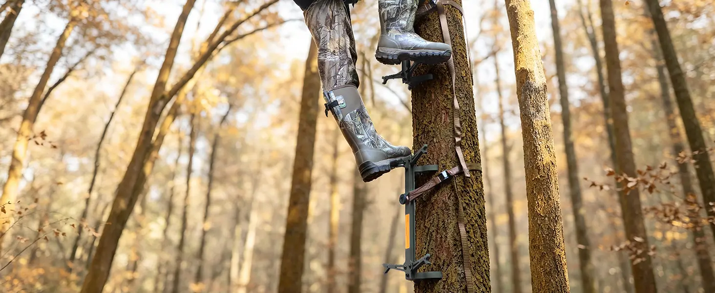 Hunter climbing a tree using hunting climbing sticks included with a hang-on tree stand system