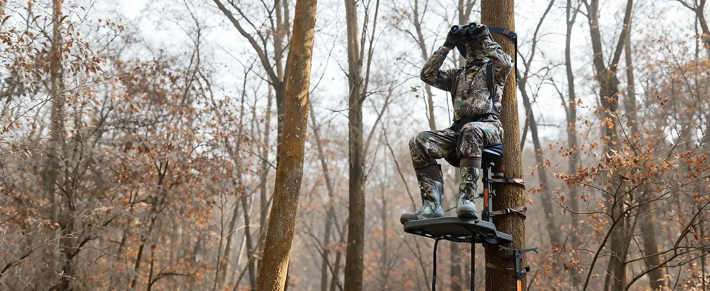 Hunter using a hang-on tree stand for whitetail deer hunting from an elevated position