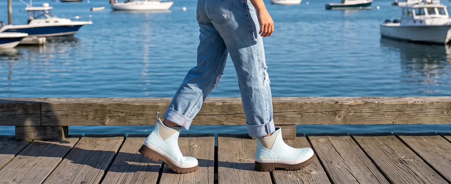 Woman wearing women's rubber mud boots walking along the dock