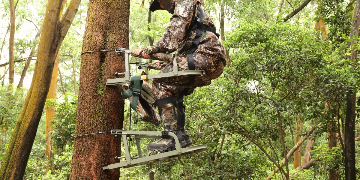 a hunter is climbing with climber stand