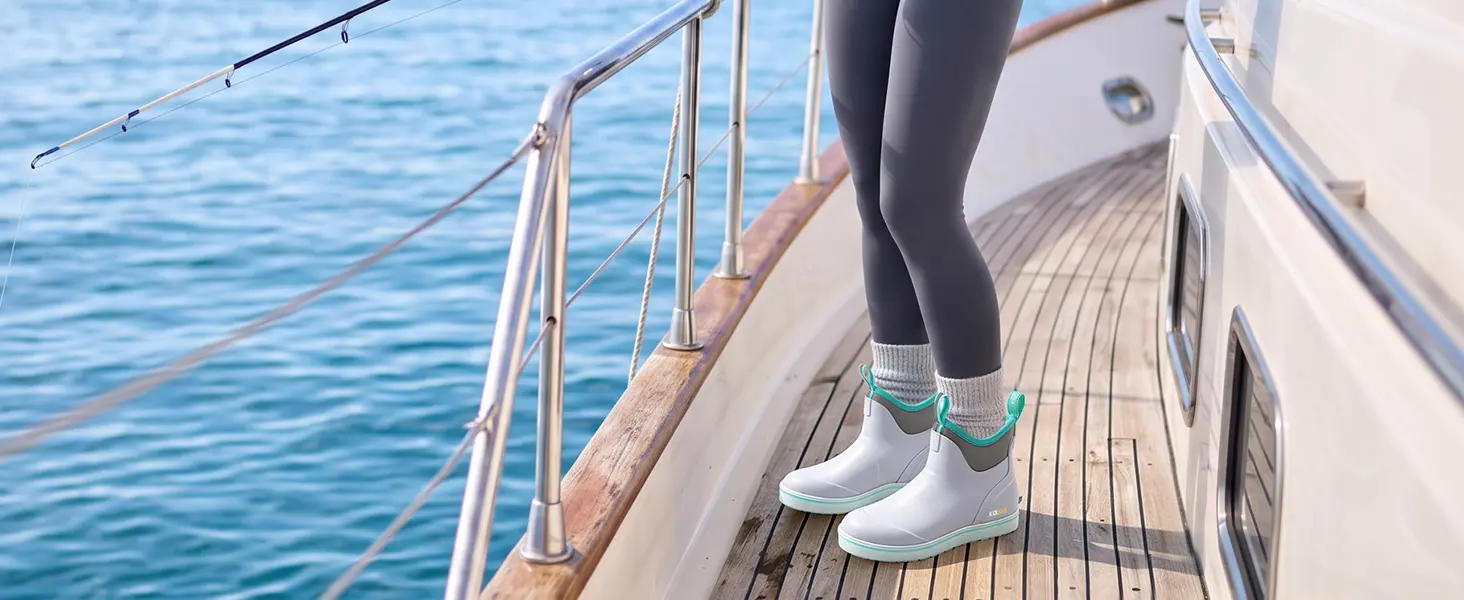 woman wears Kalkal insulated deck boots on boat deck