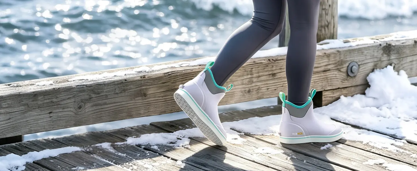 Woman wearing waterproof deck boots on a wet dock