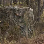 a hunting blind is decorated with natural branches for better concealment